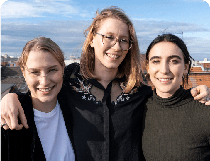 A group of three women standing next to each other